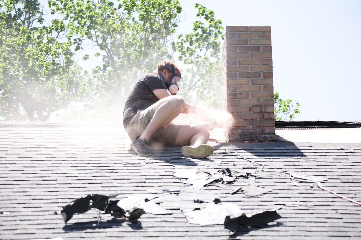 Friendly Fire technician performing chimney service on a rooftop